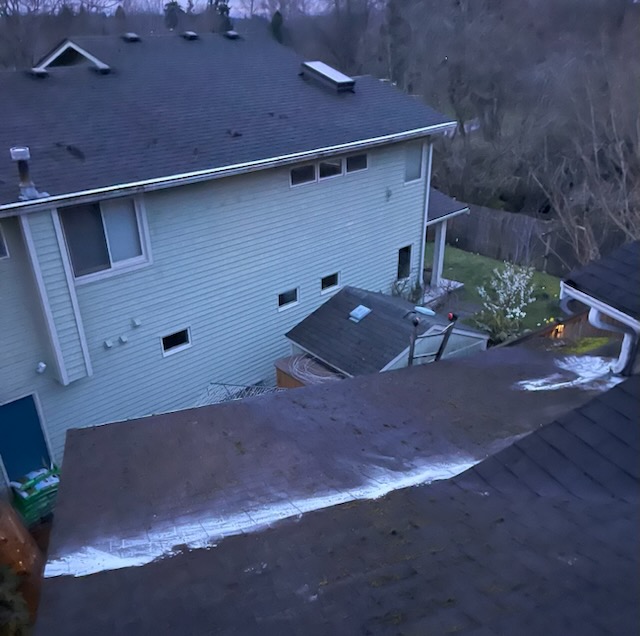 Elevated view of a two-story home roof on a frosty Washington morning